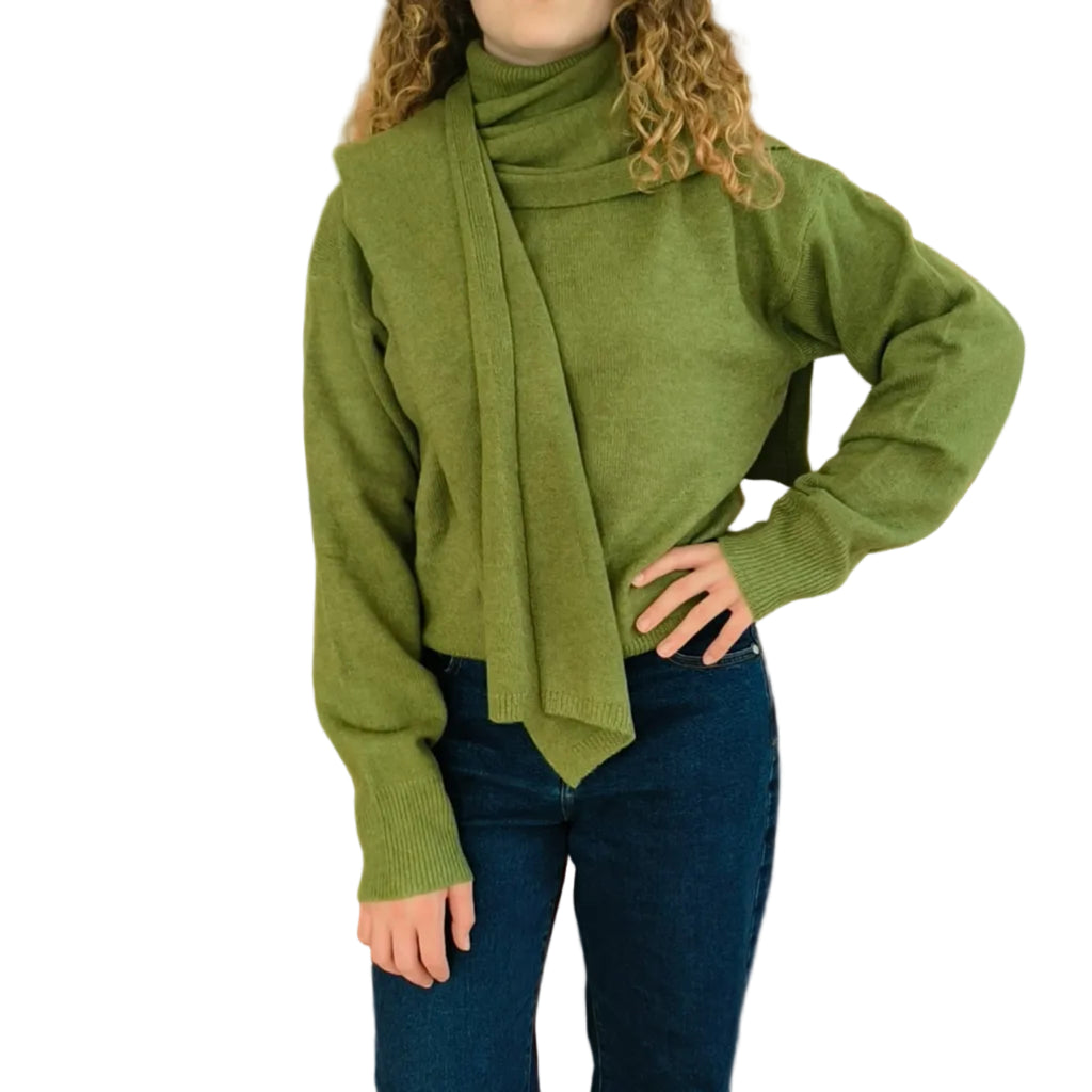 Woman wearing olive green turtleneck knit with matching cape shawl